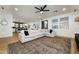 Open-concept living room featuring a large white sectional, a modern kitchen, and an adjacent dining area at 12118 W Villa Chula Ct, Sun City, AZ 85373