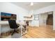 Well-lit home office with sleek desk, floating shelves, and a view of the staircase at 12118 W Villa Chula Ct, Sun City, AZ 85373