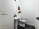 Modern powder room with a stylish pedestal sink, black fixtures, and elegant textured walls at 12118 W Villa Chula Ct, Sun City, AZ 85373