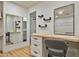 Bathroom vanity area with custom cabinets, drawers, and a lighted mirror at 12118 W Villa Chula Ct, Sun City, AZ 85373