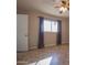 Spacious bedroom with ceiling fan and tile floors features curtains and a closet at 13134 N 20Th Ave, Phoenix, AZ 85029