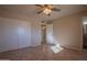 Comfortable bedroom with ceiling fan, closet and tile floors provides easy access to the bathroom at 13134 N 20Th Ave, Phoenix, AZ 85029