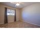 Bright bedroom with tile floors and neutral walls offers a ceiling fan and natural light at 13134 N 20Th Ave, Phoenix, AZ 85029