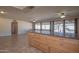 Open concept kitchen with breakfast bar and views of the bright, tile-floored living area at 13134 N 20Th Ave, Phoenix, AZ 85029