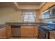 Well-lit kitchen features wood cabinets, granite countertops, and stainless steel appliances at 13134 N 20Th Ave, Phoenix, AZ 85029