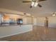 Open-concept kitchen with a breakfast bar, black appliances, and tile flooring, seamlessly blending with the living area at 13134 N 20Th Ave, Phoenix, AZ 85029