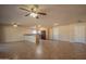 Spacious living room with neutral paint, tile floors, and ceiling fans, creating a welcoming atmosphere at 13134 N 20Th Ave, Phoenix, AZ 85029