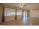 Bright living area with large windows and sliding glass doors, showcasing tile flooring and neutral walls at 13134 N 20Th Ave, Phoenix, AZ 85029