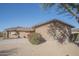 Side view of a residence featuring desert landscaping, a cozy bench, and a beautiful, mature flowering bush at 13134 N 20Th Ave, Phoenix, AZ 85029