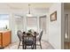 Bright dining area features a round wooden table, and natural light from the three windows at 14224 N 26Th Ln, Phoenix, AZ 85023