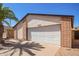 Exterior shot of the home showcasing garage with neutral color stucco and brick at 14224 N 26Th Ln, Phoenix, AZ 85023