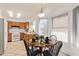 Cozy kitchen and dining area features modern appliances, a round wooden table, and natural light at 14224 N 26Th Ln, Phoenix, AZ 85023