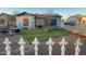 Cozy backyard featuring a well-kept lawn, patio furniture, and charming white picket fence at 1434 E Roosevelt St, Phoenix, AZ 85006