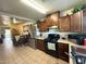 Functional kitchen featuring stainless steel refrigerator and a gas range and tile flooring at 1434 E Roosevelt St, Phoenix, AZ 85006