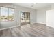 Bedroom featuring wood-style floors, a window, and sliding doors leading to a balcony at 14425 N 137Th Ln, Surprise, AZ 85379