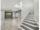 Open-concept living room with a staircase and gray accent wall at 14425 N 137Th Ln, Surprise, AZ 85379