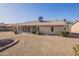 Well-kept backyard with gravel, a covered patio, and a desert landscape at 14510 W Yosemite Dr, Sun City West, AZ 85375