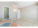 Bedroom with tile floors, ceiling fan, door, and walk-in closet at 14510 W Yosemite Dr, Sun City West, AZ 85375