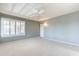 Bright main bedroom with plush carpet, ceiling fan, and plantation shutters at 14510 W Yosemite Dr, Sun City West, AZ 85375