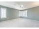 Large main bedroom with plush carpet, ceiling fan, and plantation shutters at 14510 W Yosemite Dr, Sun City West, AZ 85375