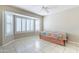 Bedroom with tile floors, bay window with shutters, and bed at 14510 W Yosemite Dr, Sun City West, AZ 85375