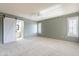 Comfortable bedroom featuring plush carpet, ceiling fan, and access to an ensuite bathroom at 14510 W Yosemite Dr, Sun City West, AZ 85375