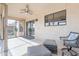 Inviting covered patio features a ceiling fan, comfortable seating, and lots of natural light at 14510 W Yosemite Dr, Sun City West, AZ 85375