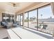 Bright, screened-in patio with comfortable seating offers serene views of the desert landscaping at 14510 W Yosemite Dr, Sun City West, AZ 85375