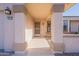 Welcoming covered front porch with decorative pillars, providing a shaded entrance to the home at 14510 W Yosemite Dr, Sun City West, AZ 85375