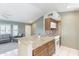 Modern kitchen with granite island, tiled backsplash, and stainless steel appliances at 14510 W Yosemite Dr, Sun City West, AZ 85375