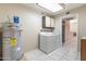 Laundry room with washer, dryer, water heater, and storage cabinets at 14510 W Yosemite Dr, Sun City West, AZ 85375