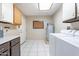 Laundry room with washer, dryer, water heater, and cabinets at 14510 W Yosemite Dr, Sun City West, AZ 85375