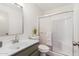 Well-lit bathroom with a modern vanity, sleek mirror, and a glass-enclosed shower at 1517 E Dunbar Dr, Tempe, AZ 85282