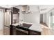 Modern kitchen island and countertops, with stainless steel appliances and a view to the hallway at 1517 E Dunbar Dr, Tempe, AZ 85282