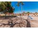 Community playground featuring tall palm trees, a swing set, a play tunnel, and a slide at 1517 E Dunbar Dr, Tempe, AZ 85282