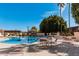 Community pool and lounge area featuring chairs, tables, and palm trees at 1517 E Dunbar Dr, Tempe, AZ 85282