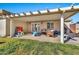 Cozy back patio under a pergola, perfect for outdoor entertaining and relaxation in the backyard at 1565 W Plana Ave, Mesa, AZ 85202