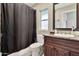 Bathroom featuring neutral walls, vanity with granite counter, sink, toilet, mirror and shower at 1565 W Plana Ave, Mesa, AZ 85202