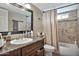 Bathroom featuring granite vanity, mirror, tile, sink, toilet, and tub-shower combo at 1565 W Plana Ave, Mesa, AZ 85202