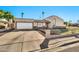 Front exterior of single Gathering home showing desert landscaping, attached garage and gated front yard at 1565 W Plana Ave, Mesa, AZ 85202