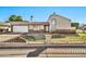 Charming single Gathering home featuring desert landscaping and an attached two car garage in front exterior at 1565 W Plana Ave, Mesa, AZ 85202