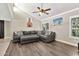 Living room boasting high ceilings, wood flooring and a comfortable sectional sofa with throw pillows at 1565 W Plana Ave, Mesa, AZ 85202