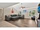 Bright living room with vaulted ceiling, large windows, ceiling fan and comfortable seating area for relaxing at 1565 W Plana Ave, Mesa, AZ 85202