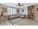 Living room showcases neutral walls, tile flooring and a furniture display cabinet with display shelves at 1565 W Plana Ave, Mesa, AZ 85202