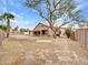 Wide backyard with covered patio, desert landscaping, mature trees and block fence at 15819 W Ripple Rd, Goodyear, AZ 85338