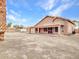 Wide backyard featuring a covered patio, a shed, and secure fencing, with desert vegetation at 15819 W Ripple Rd, Goodyear, AZ 85338