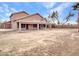 Large backyard view showcasing covered patio, mature trees and desert landscaping at 15819 W Ripple Rd, Goodyear, AZ 85338