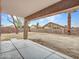 Backyard featuring a large, covered patio with concrete flooring and an expansive lawn area at 15819 W Ripple Rd, Goodyear, AZ 85338