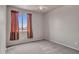 Bedroom with carpet and a window covered by long flowing red curtains at 15819 W Ripple Rd, Goodyear, AZ 85338