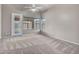 Bright and airy bedroom with neutral walls, plush carpeting, large windows, and a sliding door at 15819 W Ripple Rd, Goodyear, AZ 85338